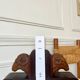 Pair of carved wooden bookends in the shape of ram's heads.
