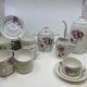 Porcelain coffee service with floral decoration and silver trim.