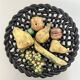 Large woven bowl and trompe l'œil fruits