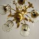 Golden metal chandelier in crystal pendants