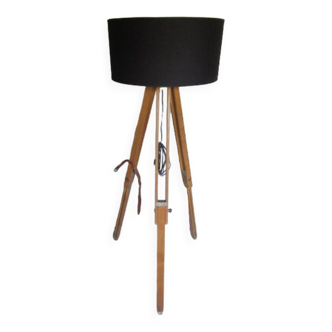 Old floor lamp on surveyor's tripod