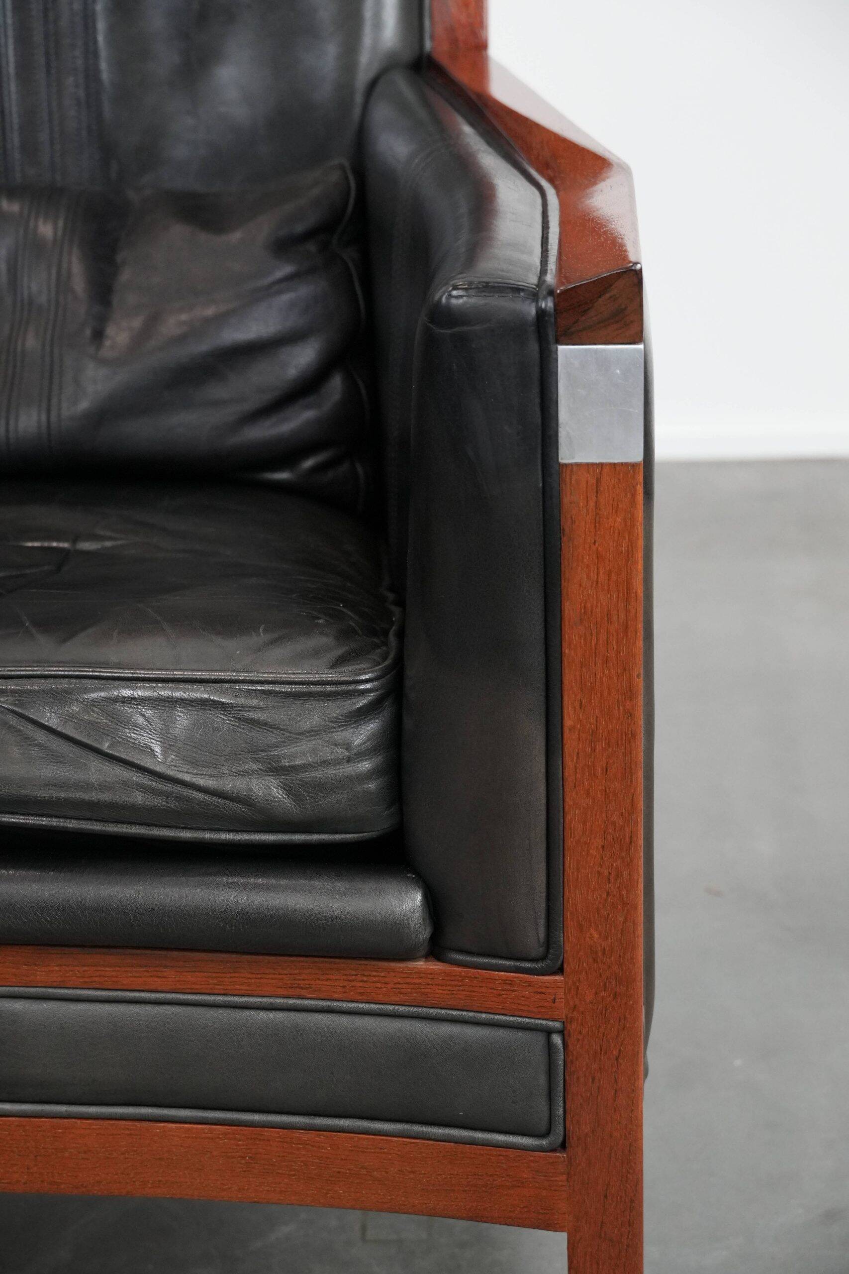 Black cowhide leather and wooden Art Deco design armchair