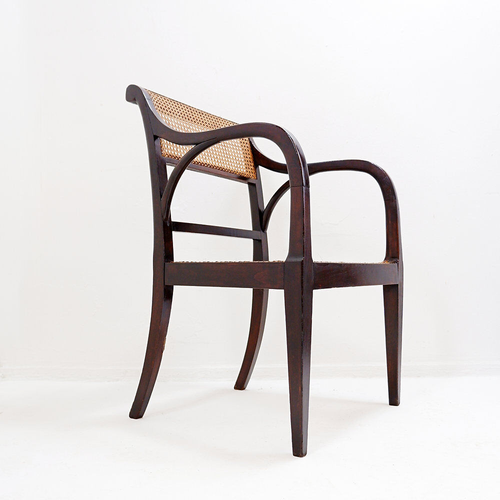 Mid-century curved wooden chairs with cane seats and backs.