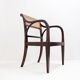 Mid-century curved wooden chairs with cane seats and backs.