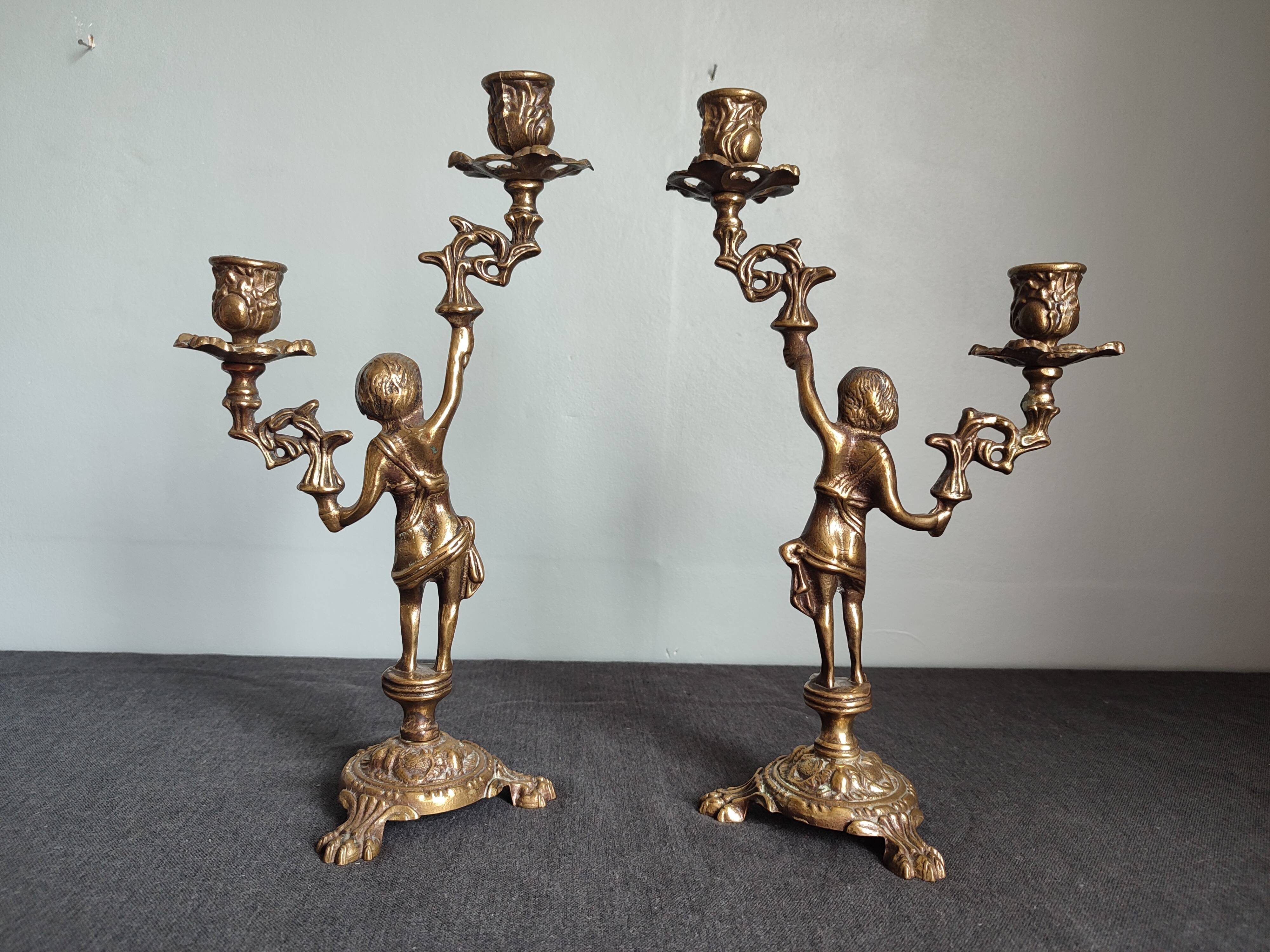 Pair of antique candlesticks in cherub bronze