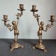 Pair of antique candlesticks in cherub bronze