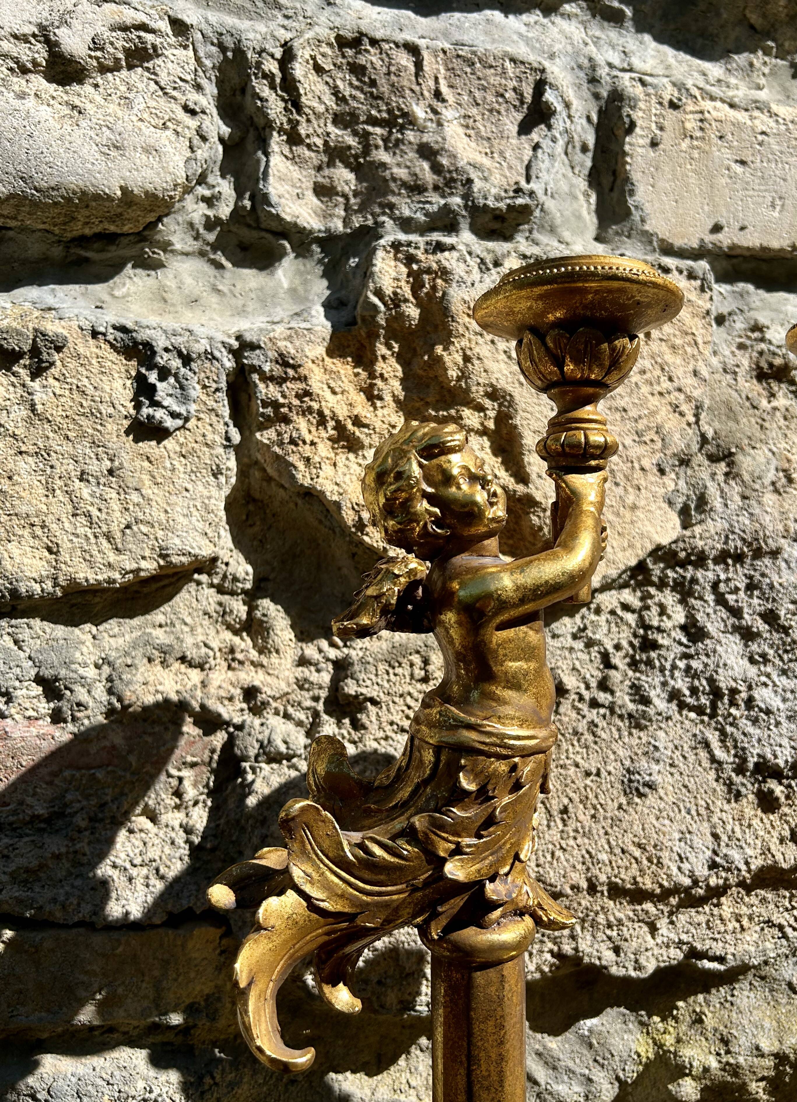 Pair of large candlesticks with cherubs