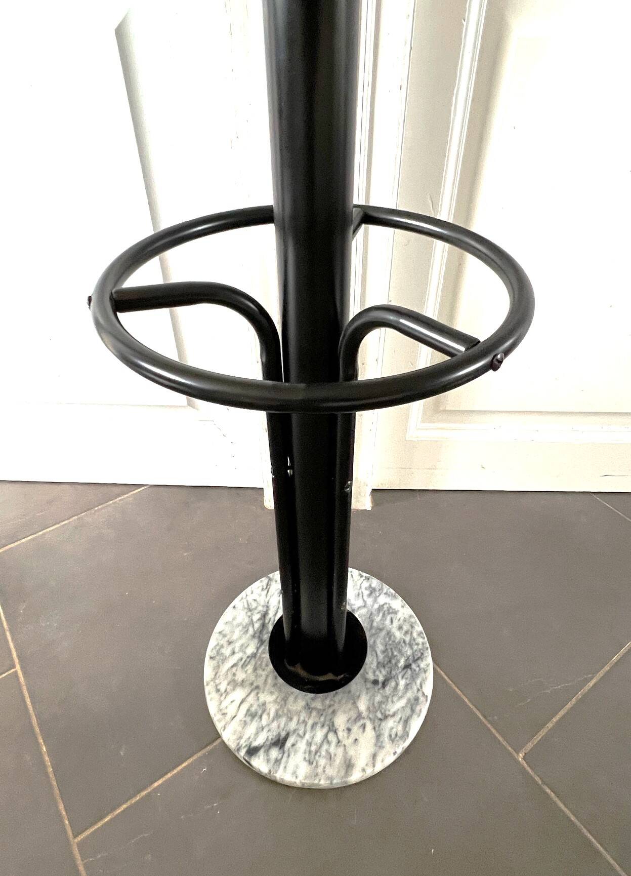 Black metal parrot coat rack on marble base