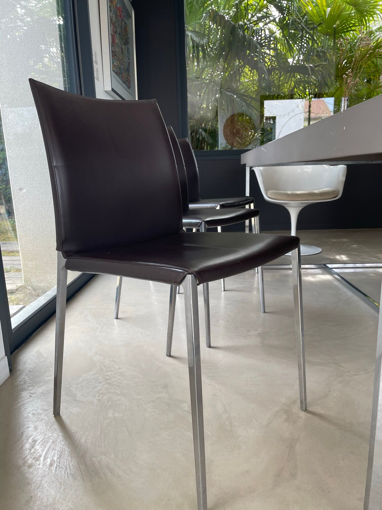 Brown leather chairs and Zanotta metal legs