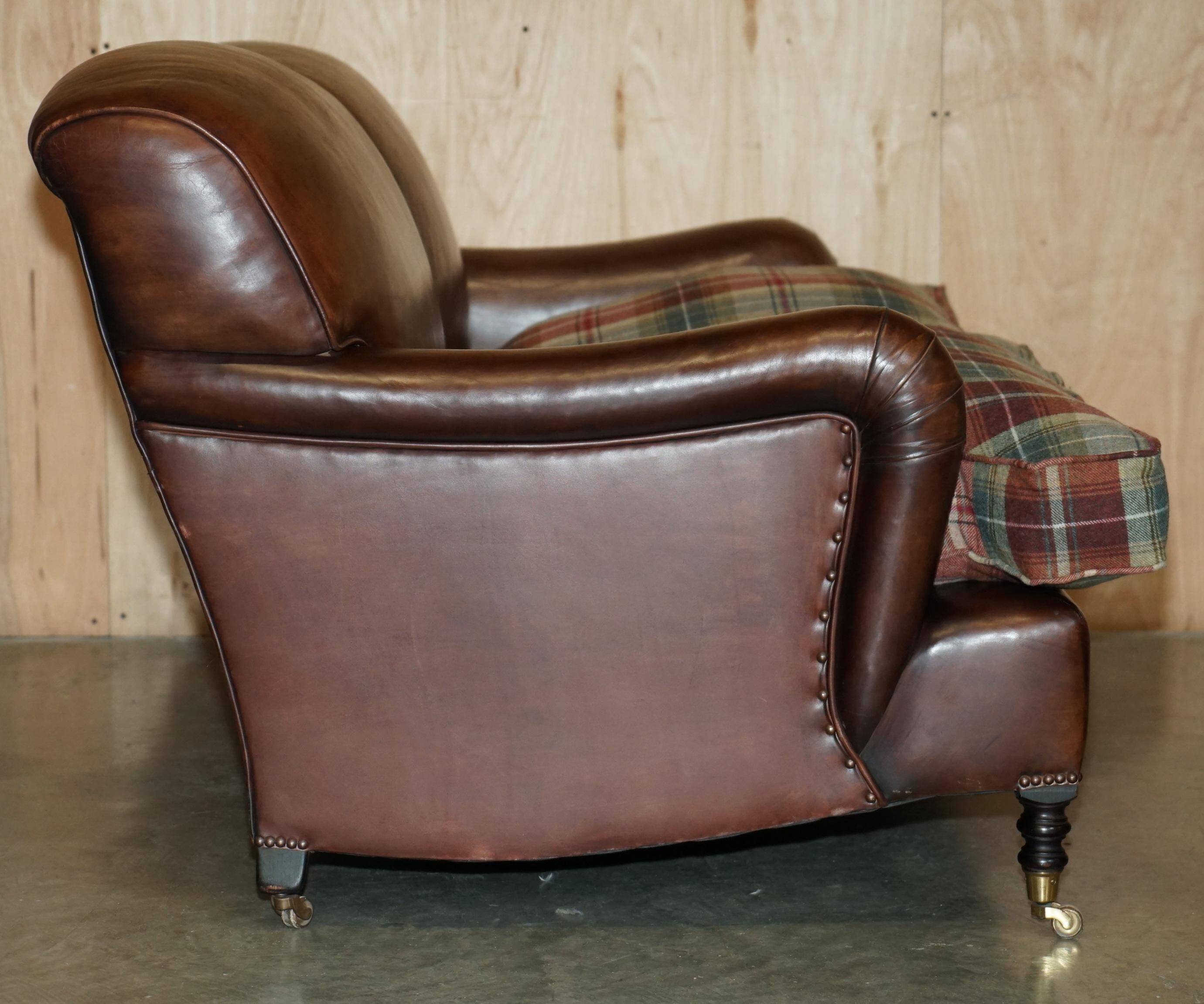 George Smith Signature Scroll leather canapé with tartan Scottish wool cushions.