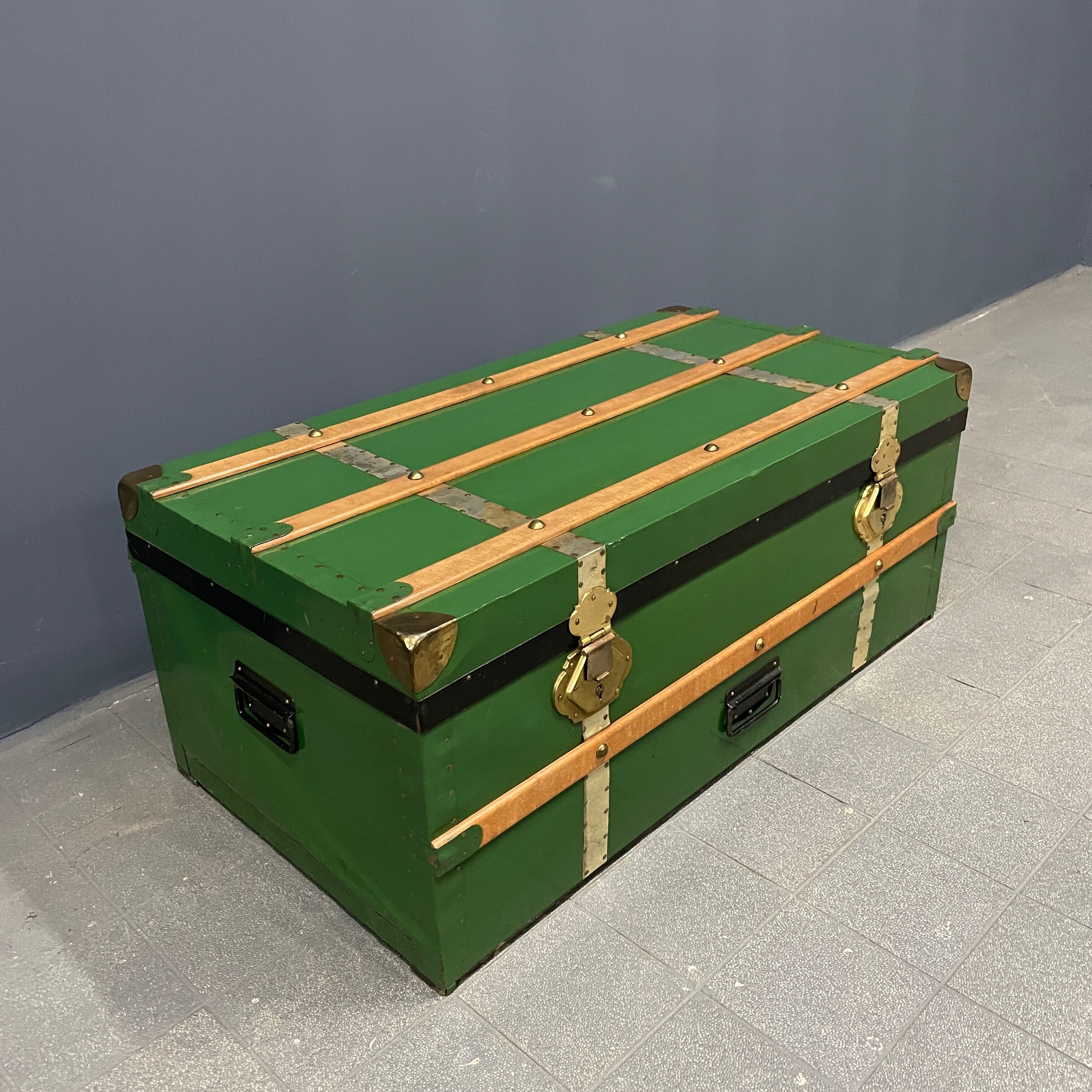 Green metal trunk with wooden sleds