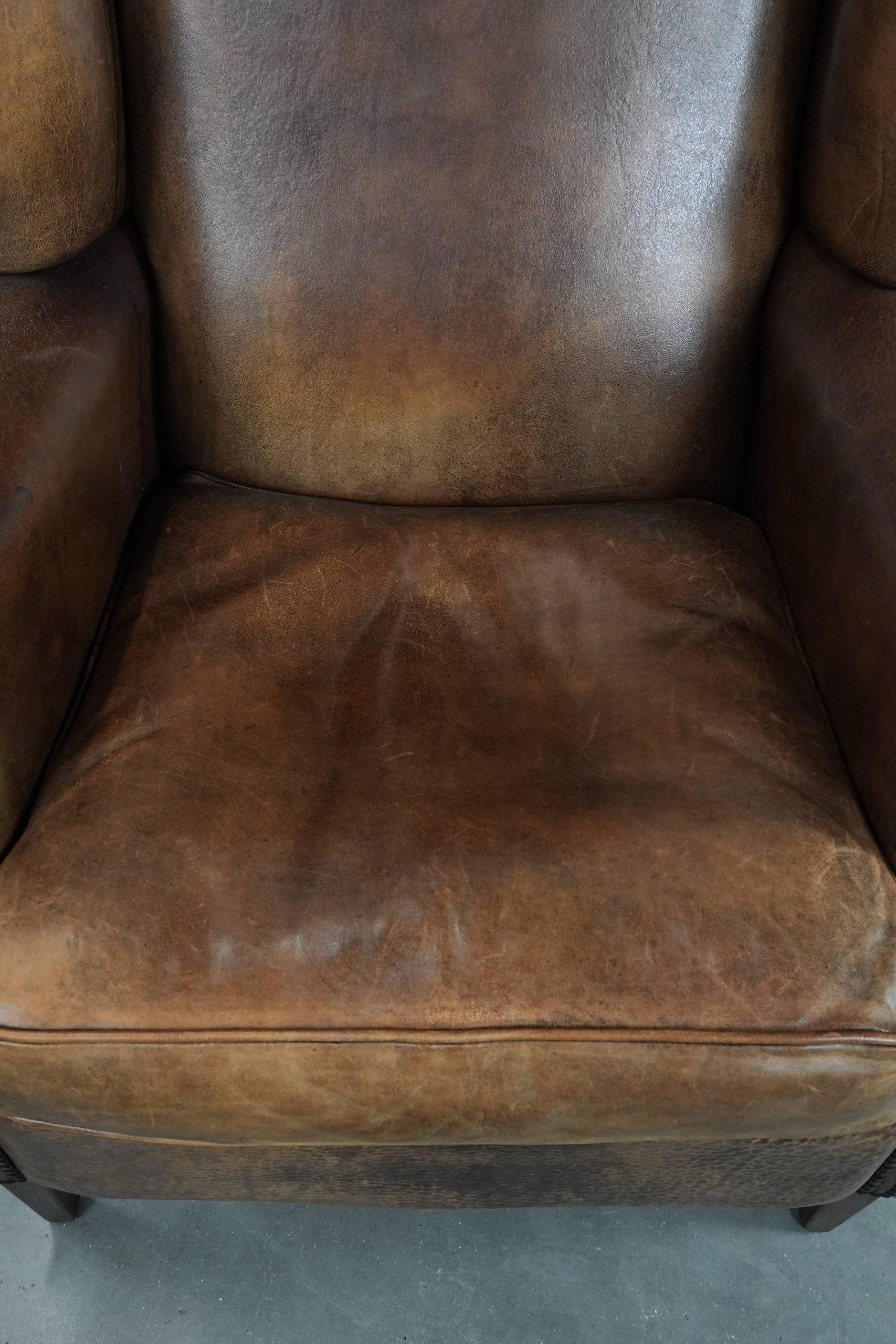 Warm, cosy and comfortable vintage sheepskin ear armchair with character