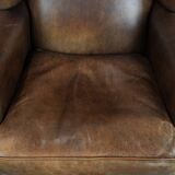Warm, cosy and comfortable vintage sheepskin ear armchair with character