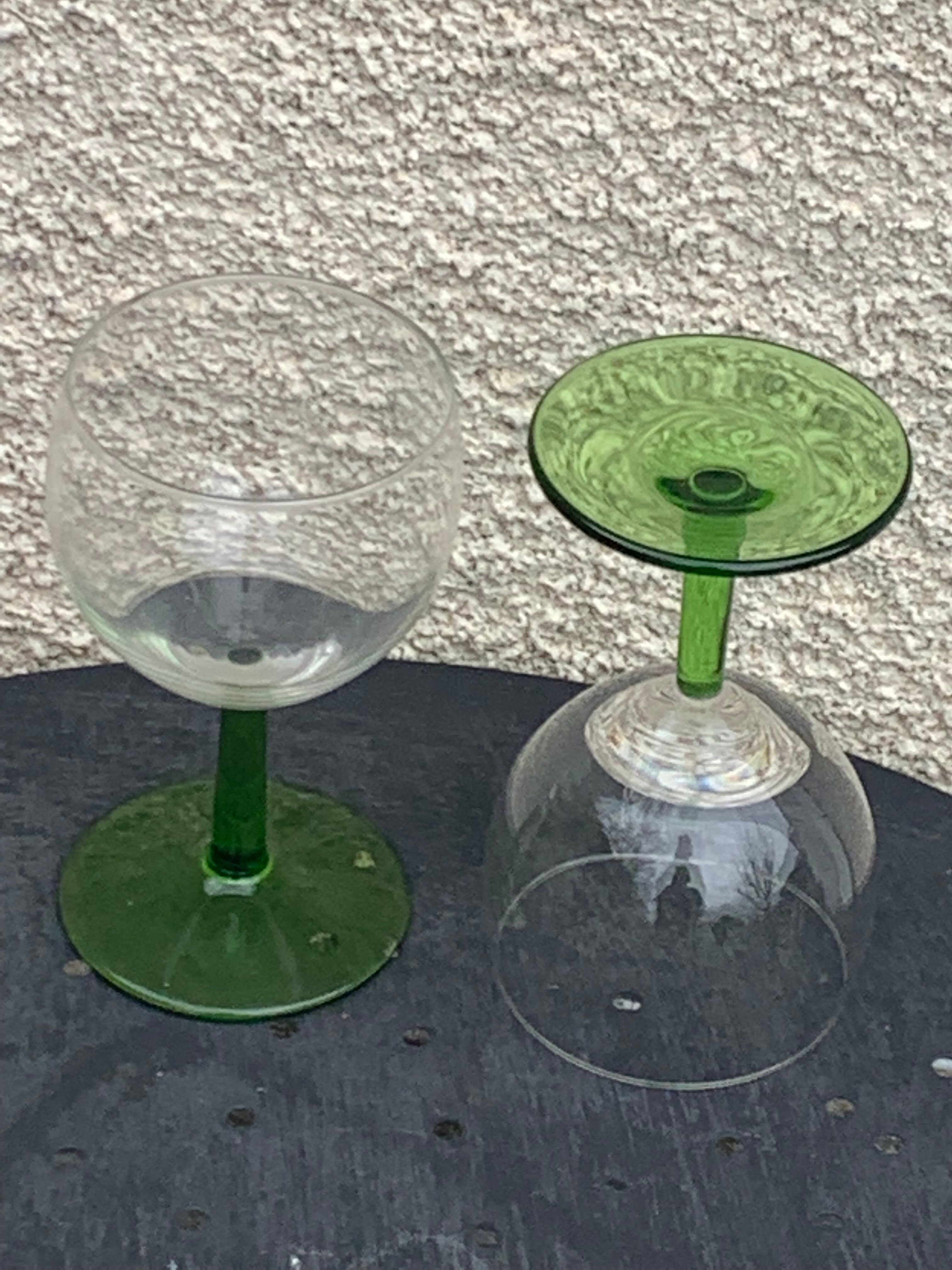 5 transparent glass glasses and green glass vase go
