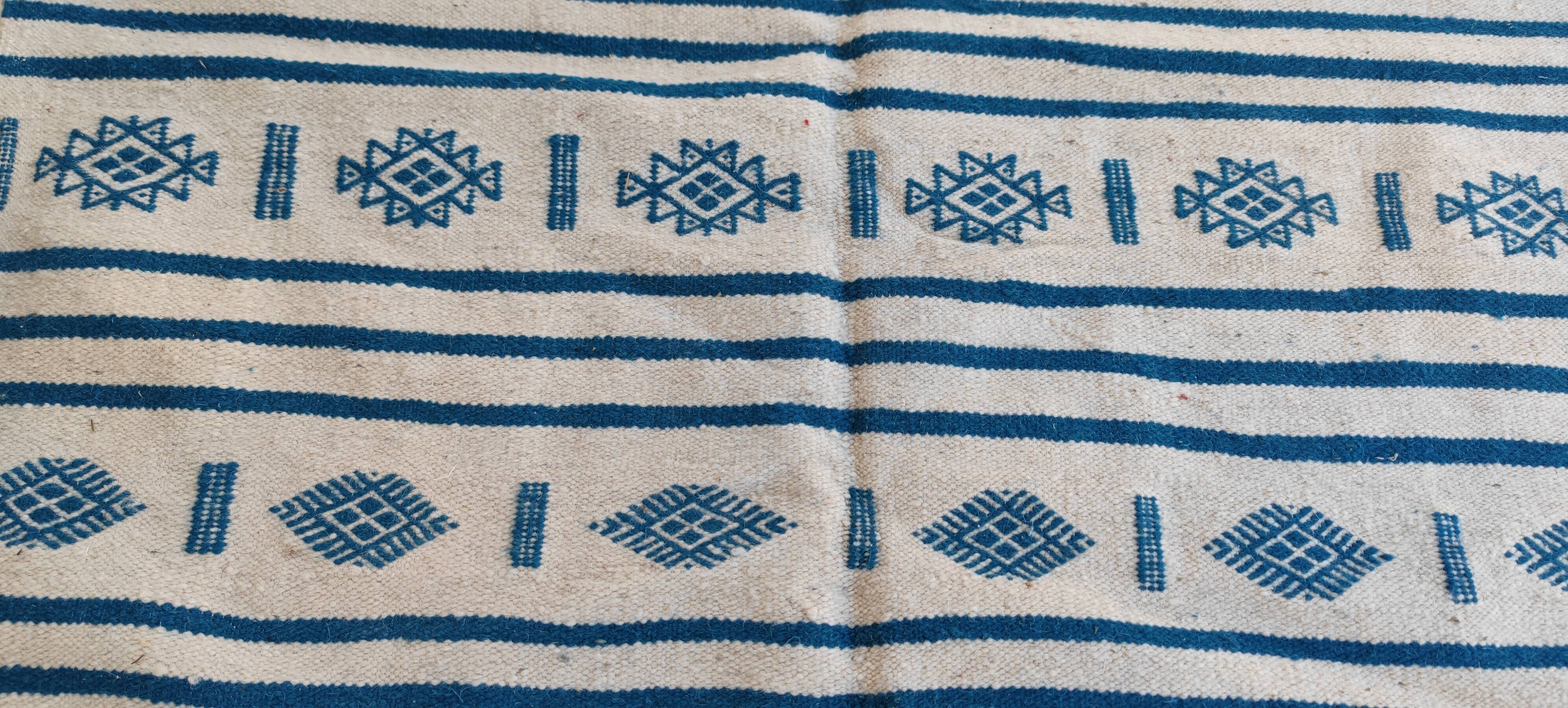 Traditional handmade white and blue kilim rug in natural wool