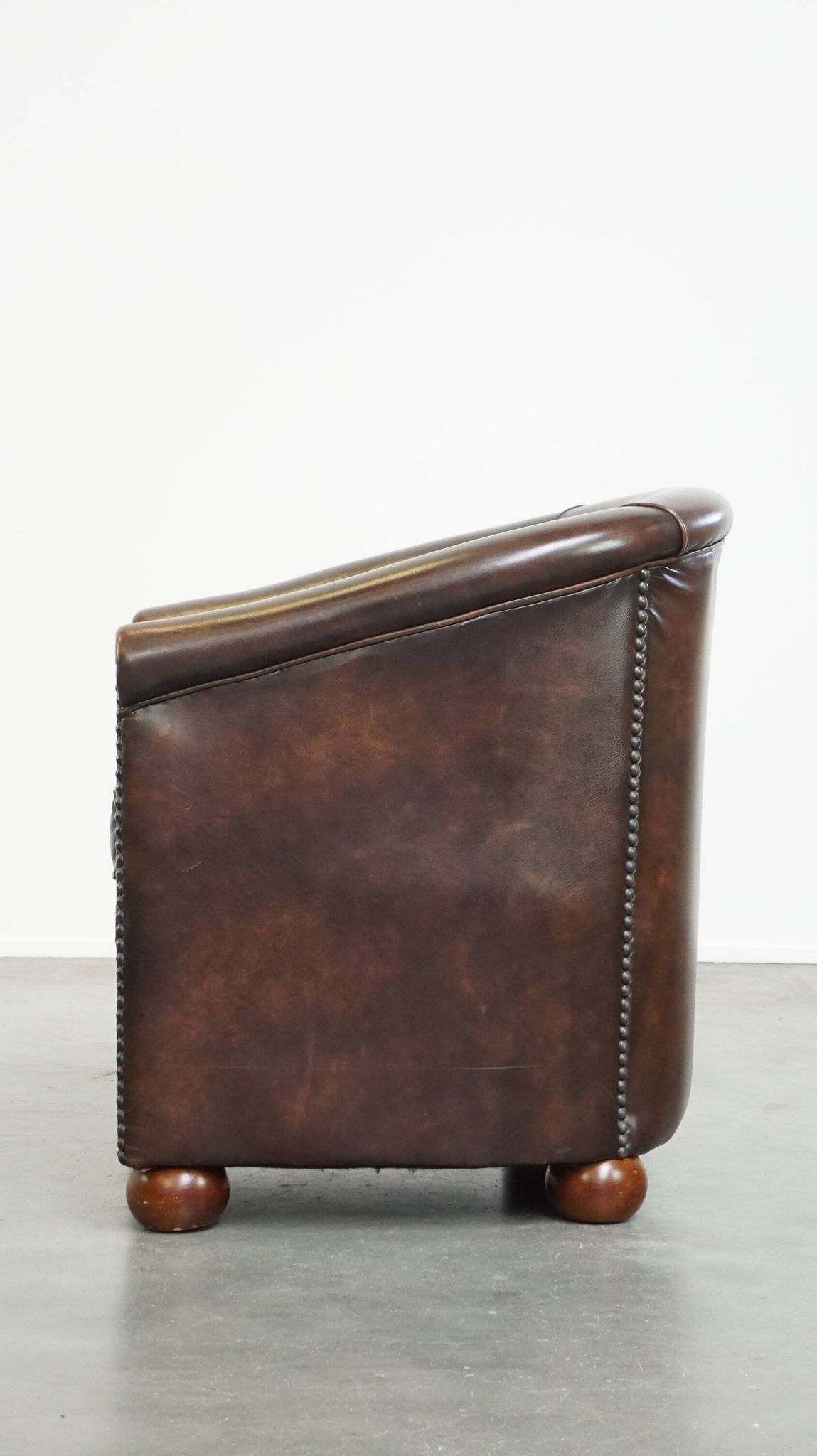 luxury dark leather club chair with English-style ball feet