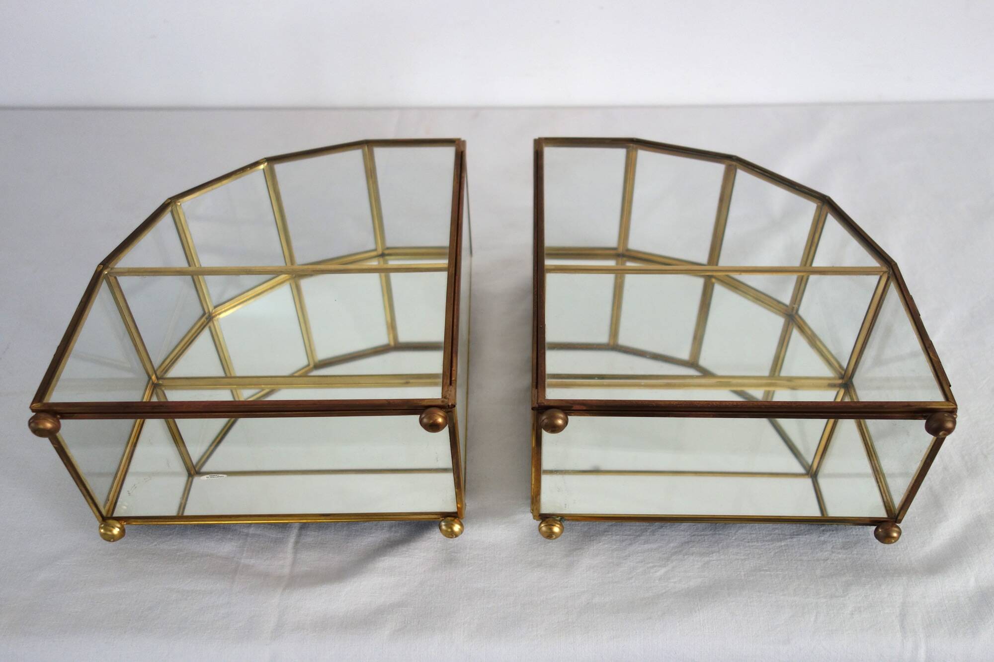 Pair of gilded brass, glass, mirror display cases from the 60s