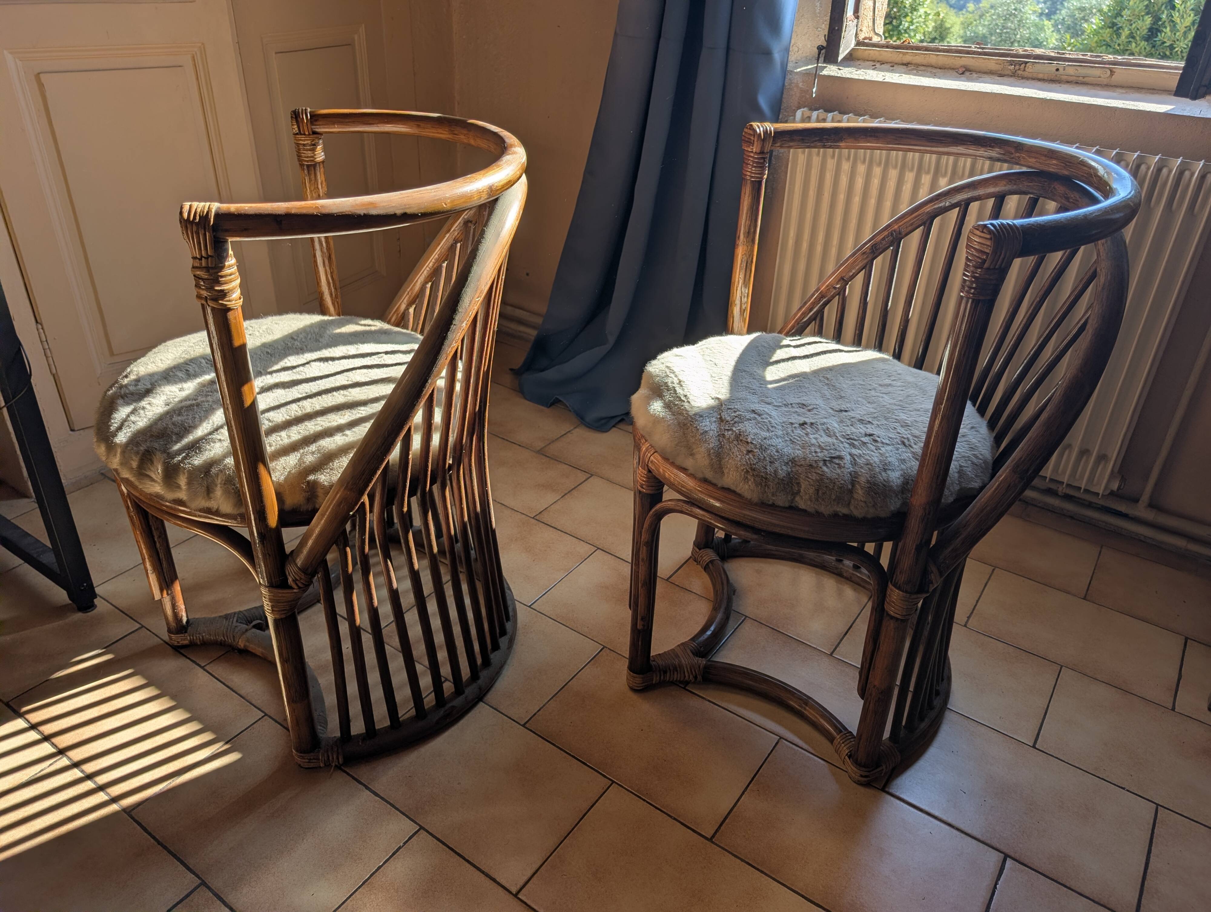 Pair of vintage rattan armchairs with soft fabric seats