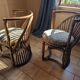 Pair of vintage rattan armchairs with soft fabric seats