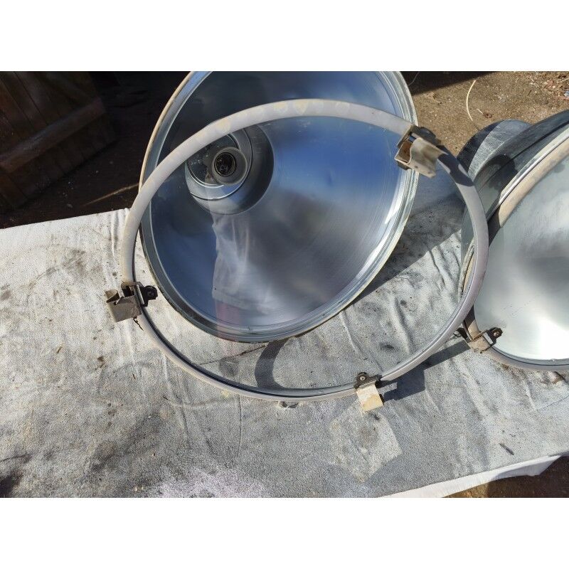 Pair of industrial pendant lights in aluminium and glass.