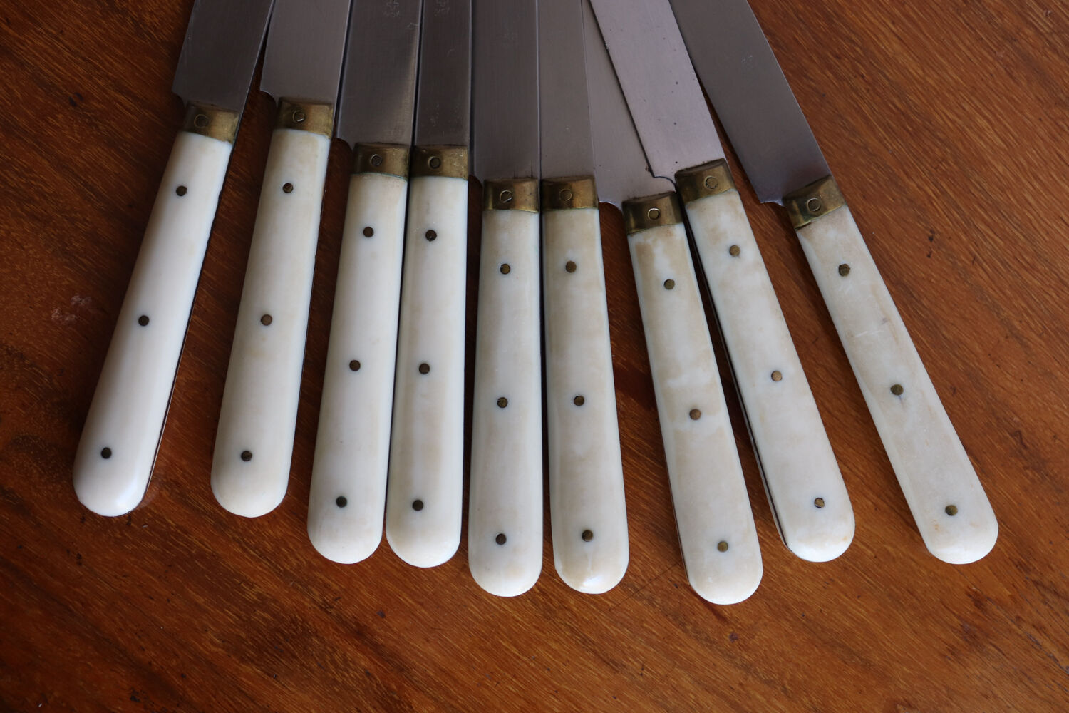 Set of 9 vintage cream table knives