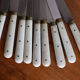 Set of 9 vintage cream table knives
