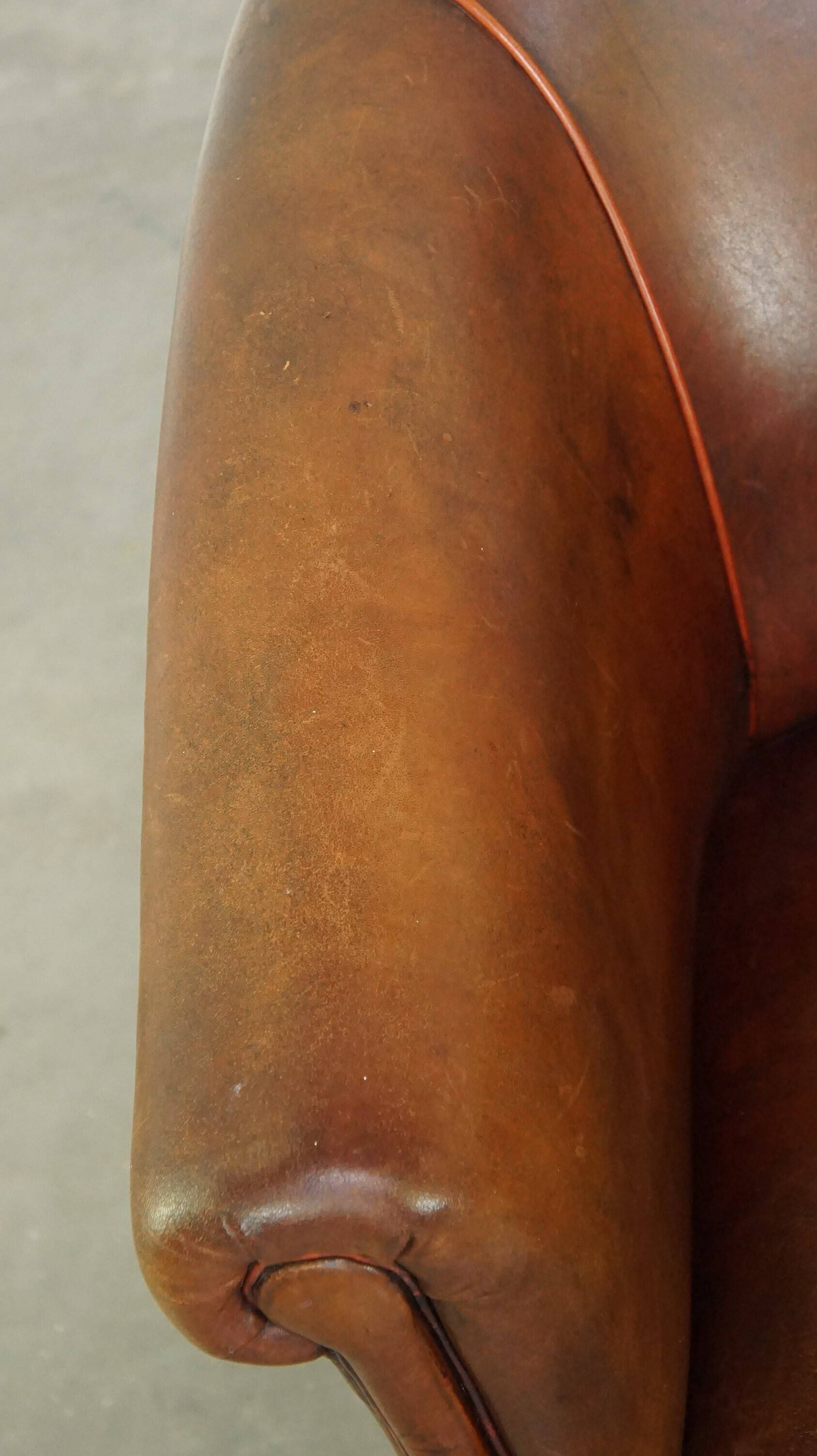 Neat, elegantly finished, cozy sheepskin club armchair with a fixed seat cushion