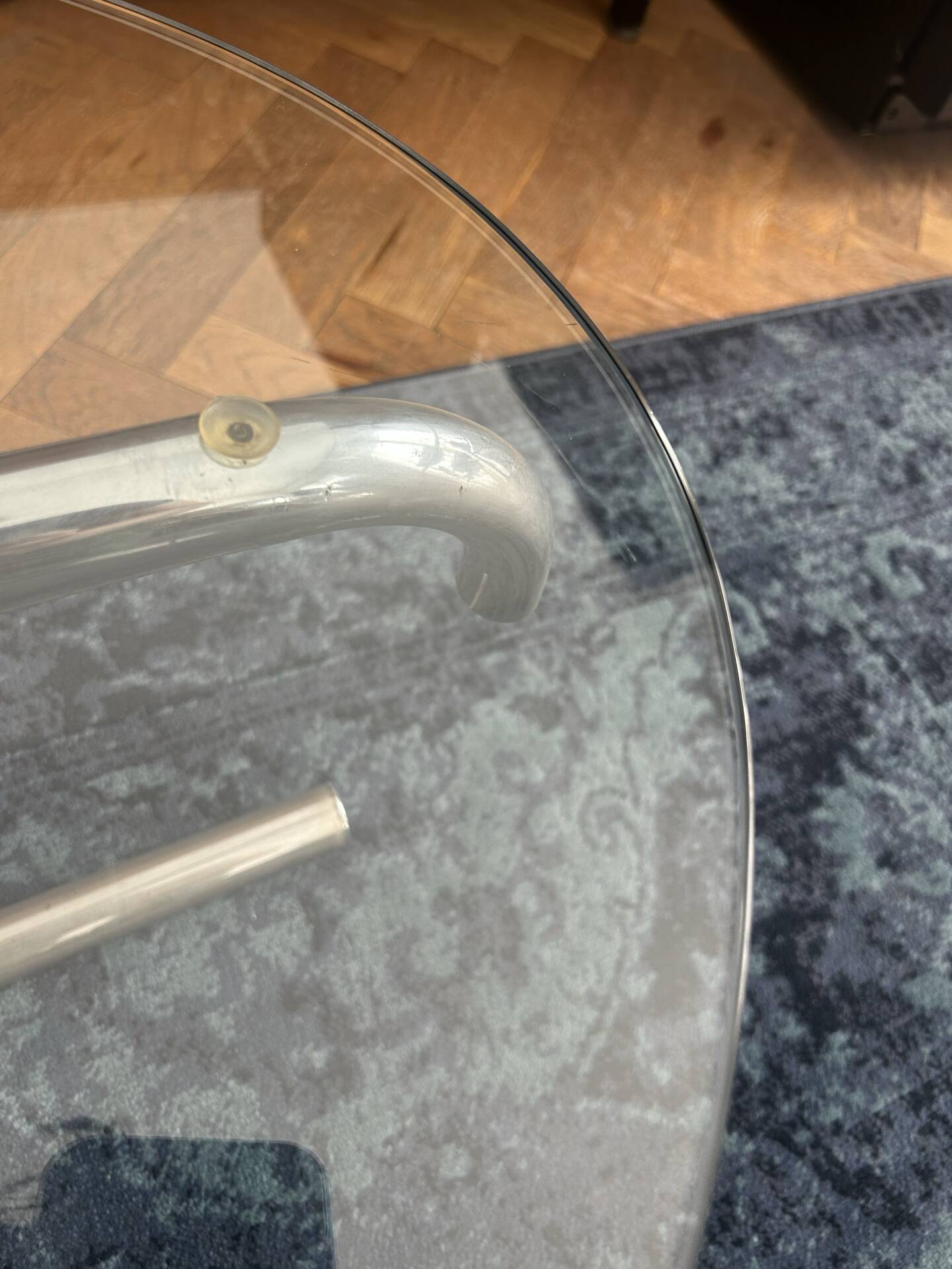 Oval glass coffee table with chrome legs, vintage 70s design.