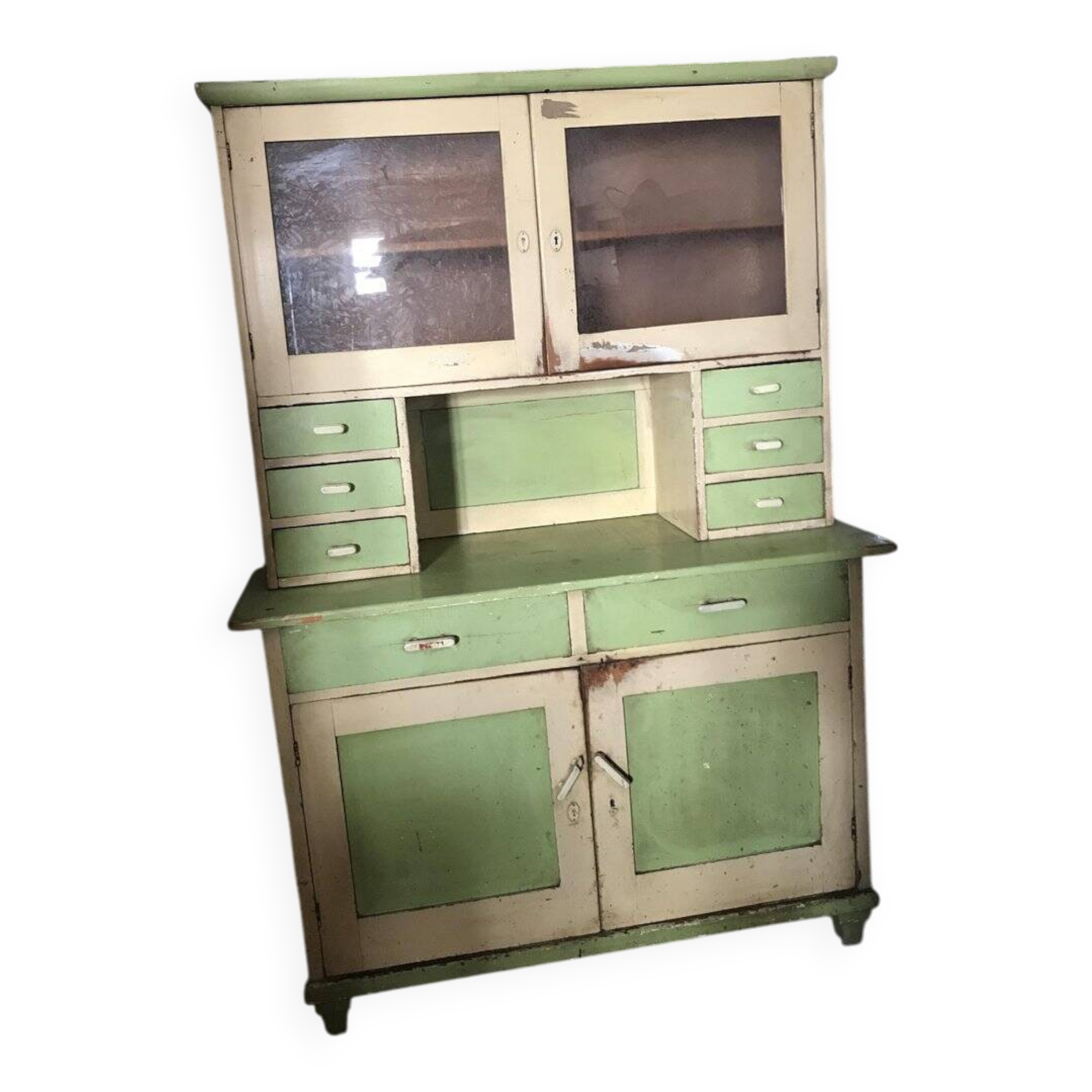 Vintage wooden kitchen cupboard painted green and beige, with glass doors - 1930s