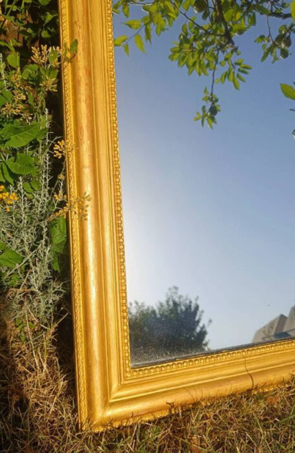 Antique Louis-Philippe mirror, gilded and patinated.