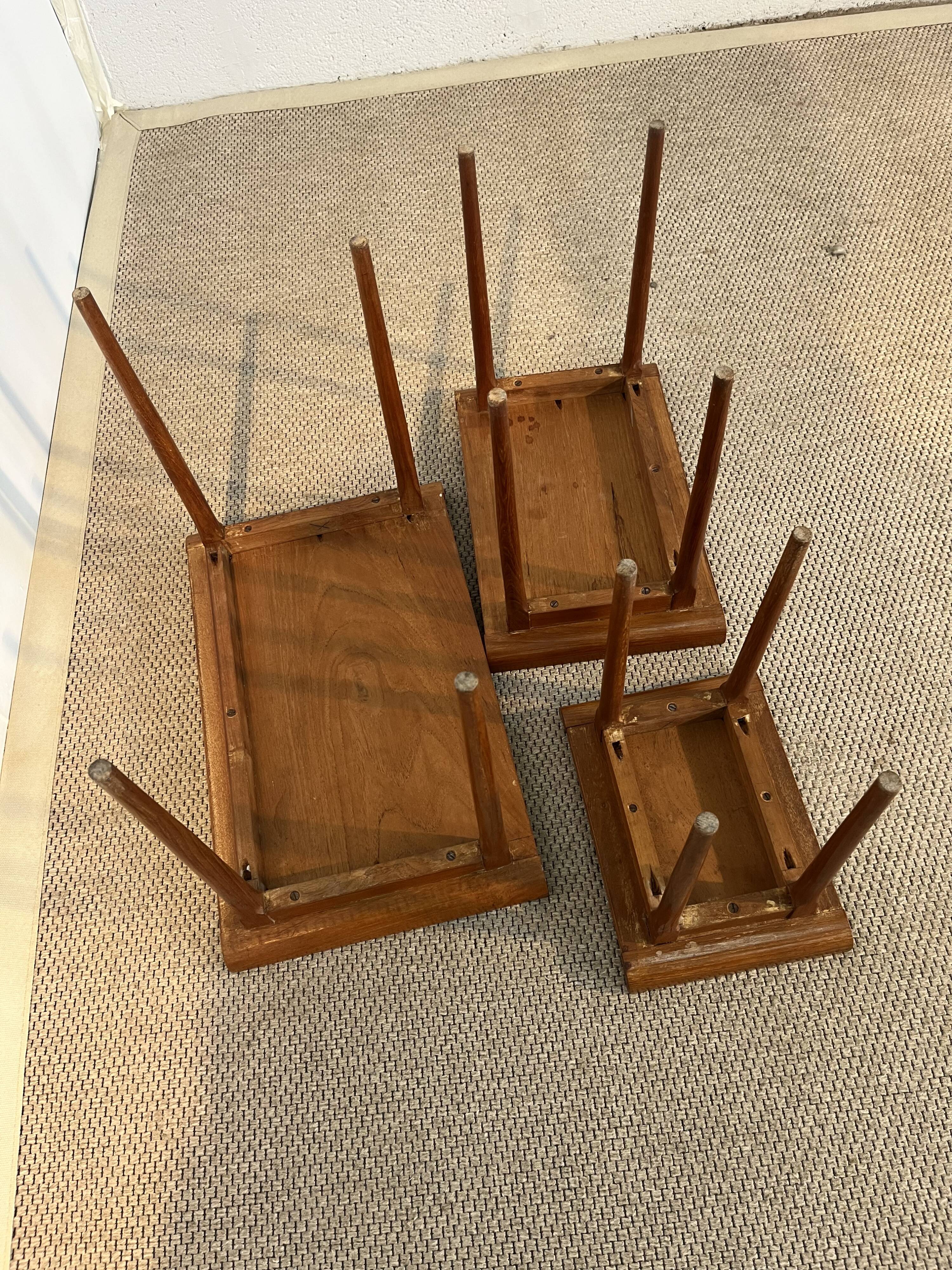 Set of three nesting low tables in a Japanese style, made of mahogany.