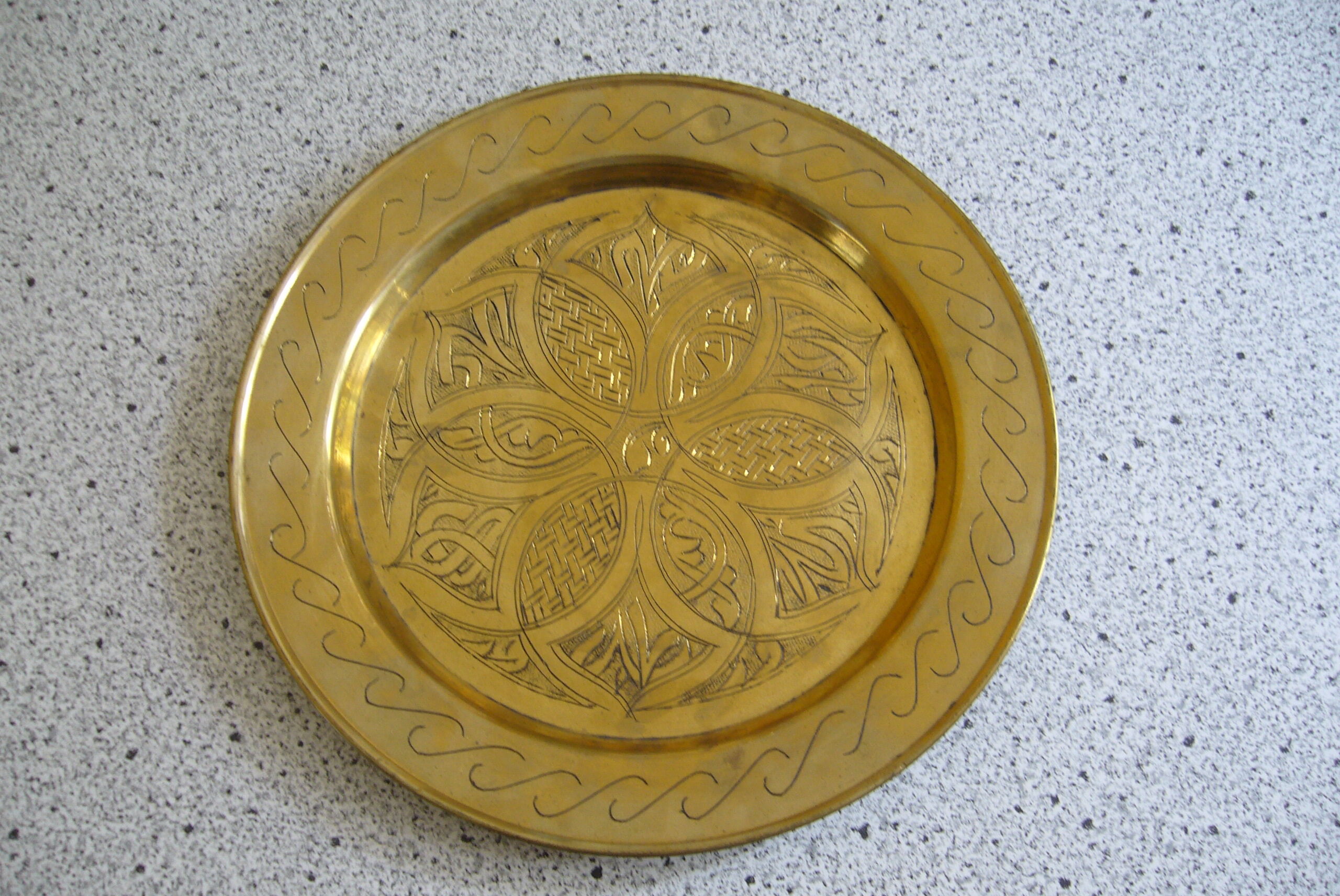 Oriental style chiseled metal plate