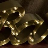 Enseigne lumineuse en lettrage aluminium formant le mot "bar"