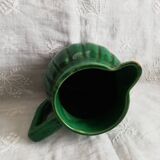 Old green pitcher in dabbling