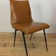 Pair of 1950s chairs with compass legs and brown faux leather.