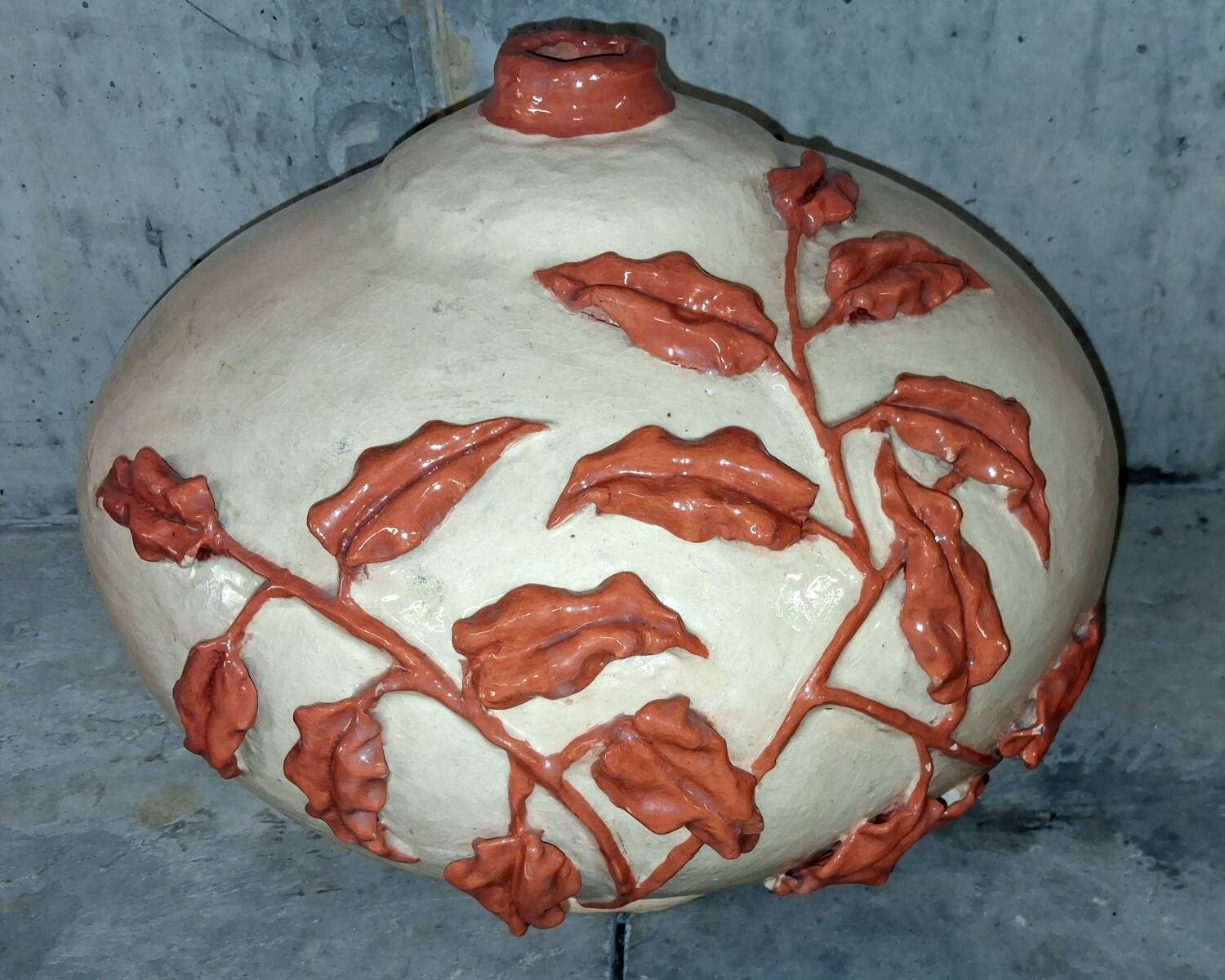 Large vase with relief plant decoration, raw art.