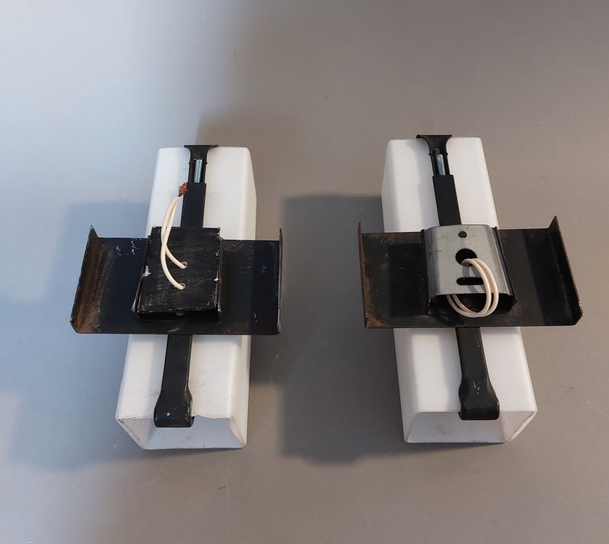 Pair of modernist sconces in black metal and white opaline vintage