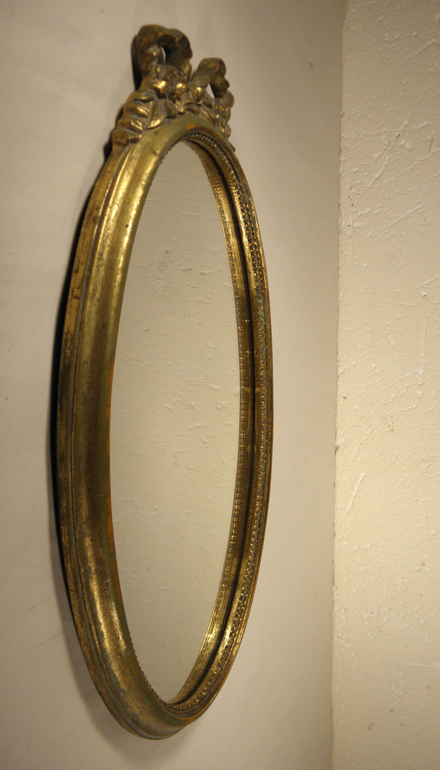 Golden oval mirror