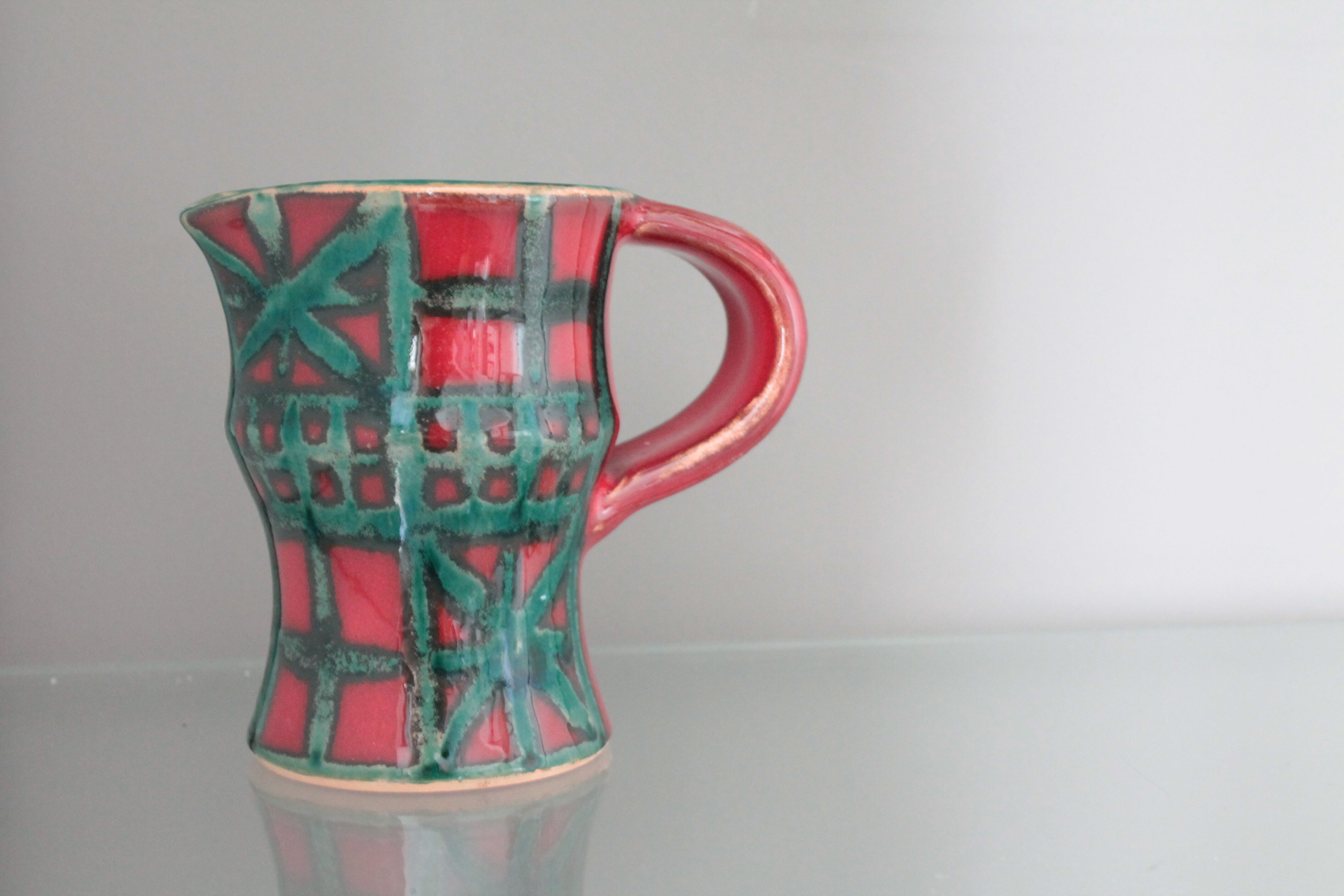 Vintage pitcher red and green art pottery