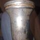 Antique cut glass spirit decanter with silver-plated neck and spout.