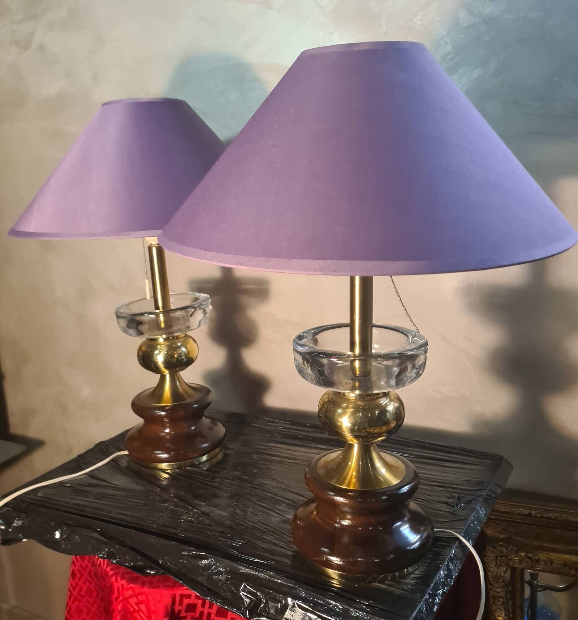 A pair of vintage table lamps featuring a turned wooden base, accessories...