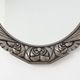 French Art Deco Oval Mirror with Carved Roses and Silver-Painted Frame