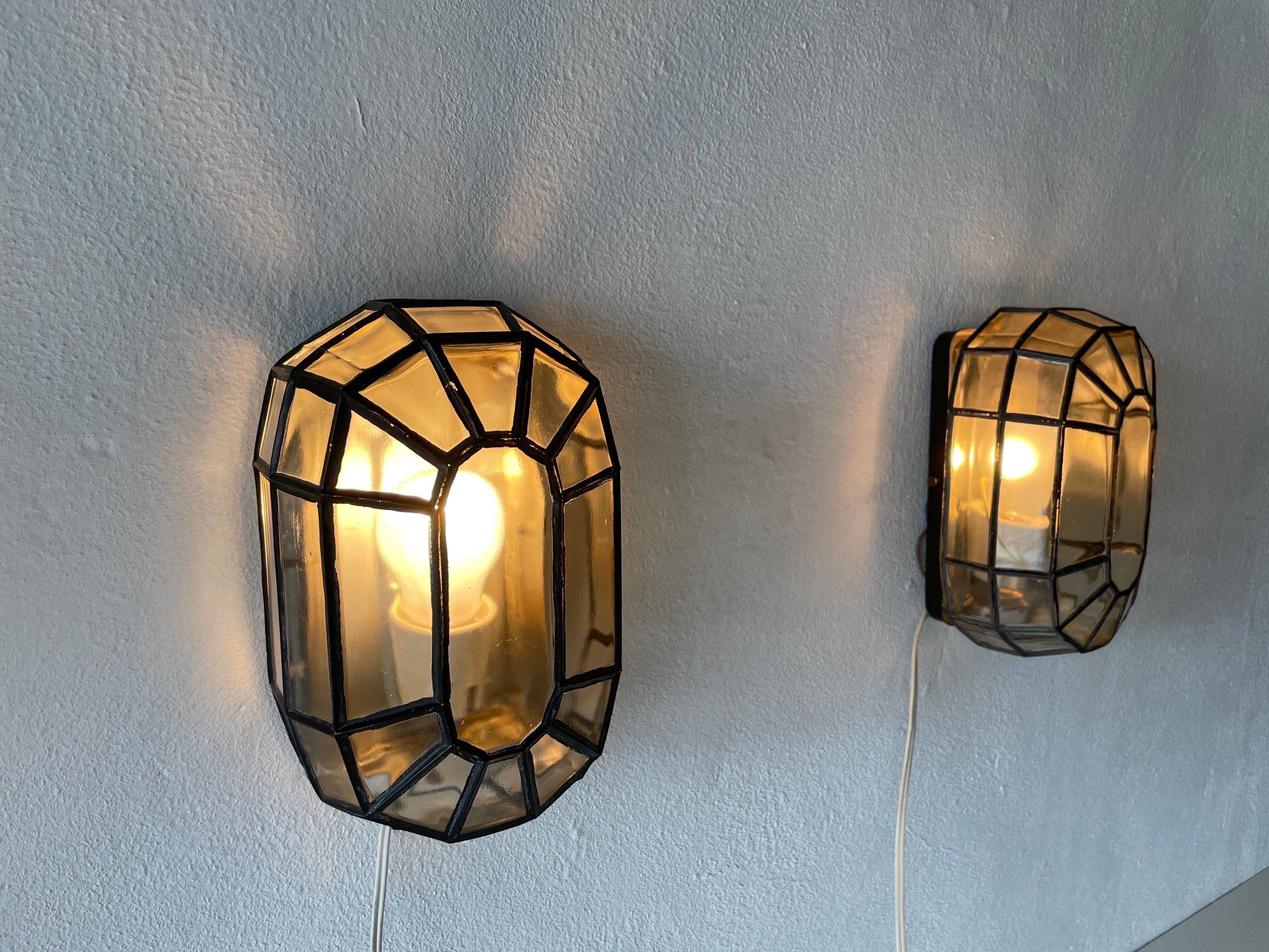 Pair of black iron wall sconces with structured glass by Limburg, 1960s, Germany.