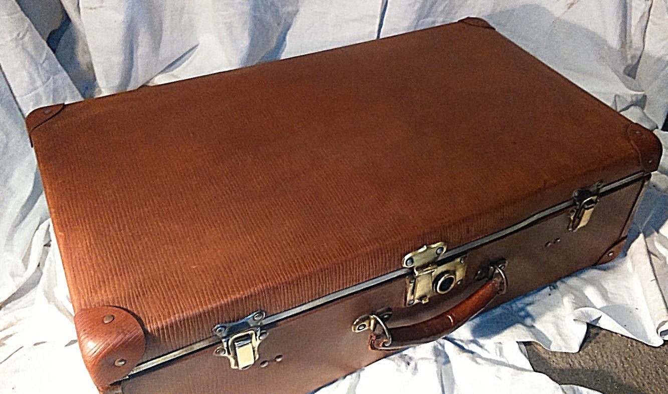 Old vintage black and white cardboard storage suitcase travel