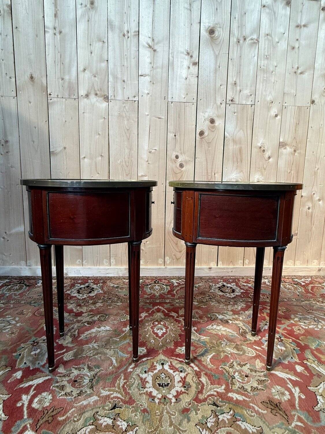 Pair of oval Louis XVI bedside tables in mahogany.