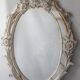 Antique oval mirror carved in wood.