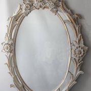 Antique oval mirror carved in wood.
