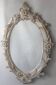 Miroir ovale ancien sculpté en bois.