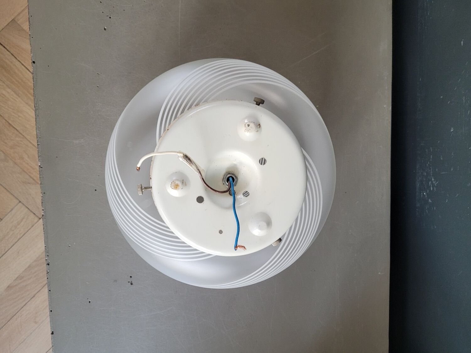 Frosted glass globe ceiling light with spiral patterns.