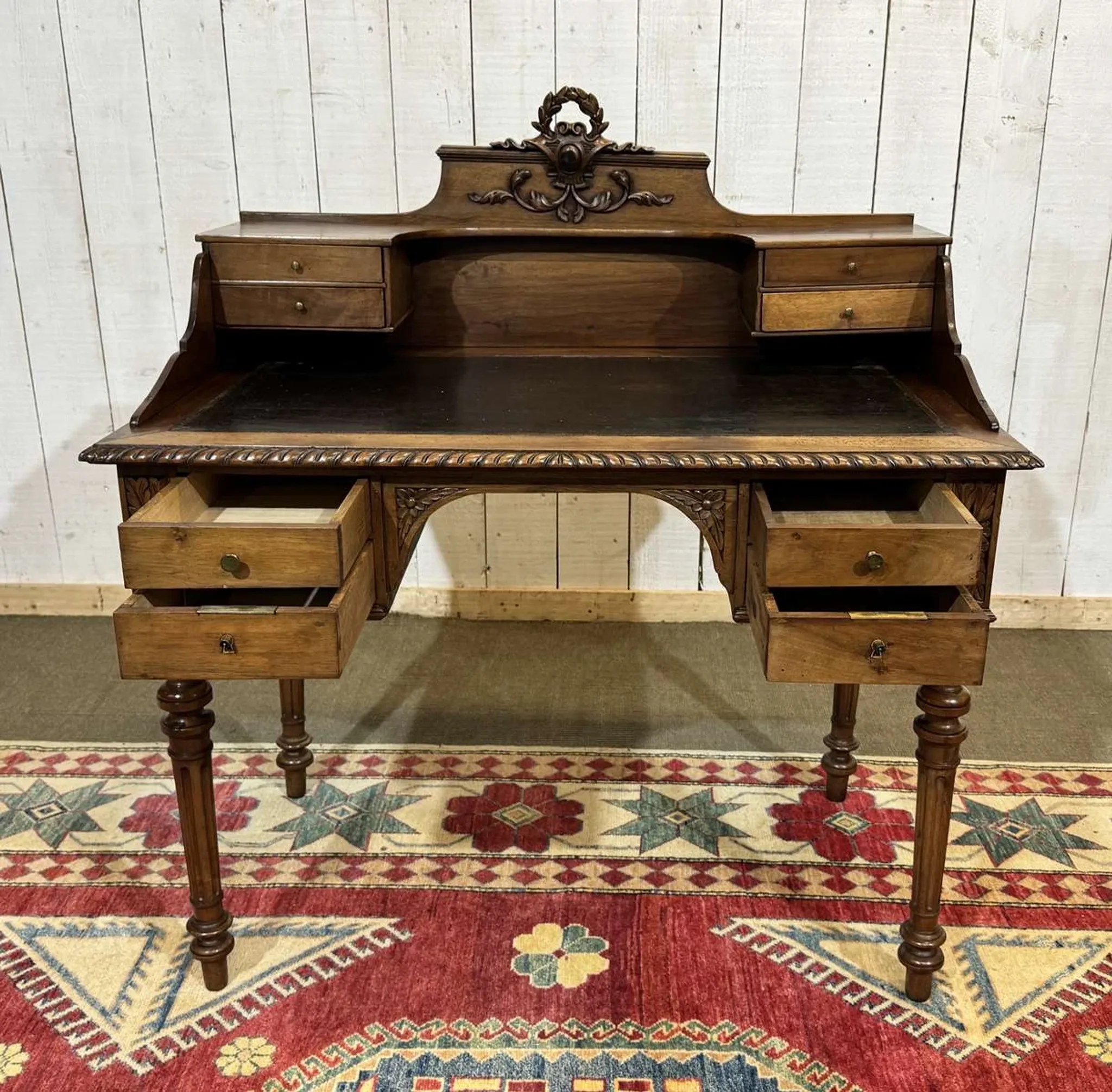 Louis XVI style desk from the late 19th century in walnut with a leather top.